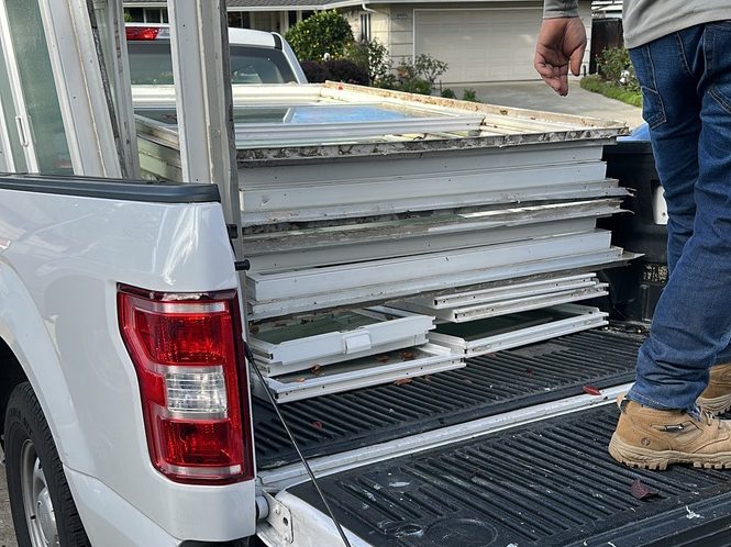 Old windows loaded into the pickup truck for a small haul