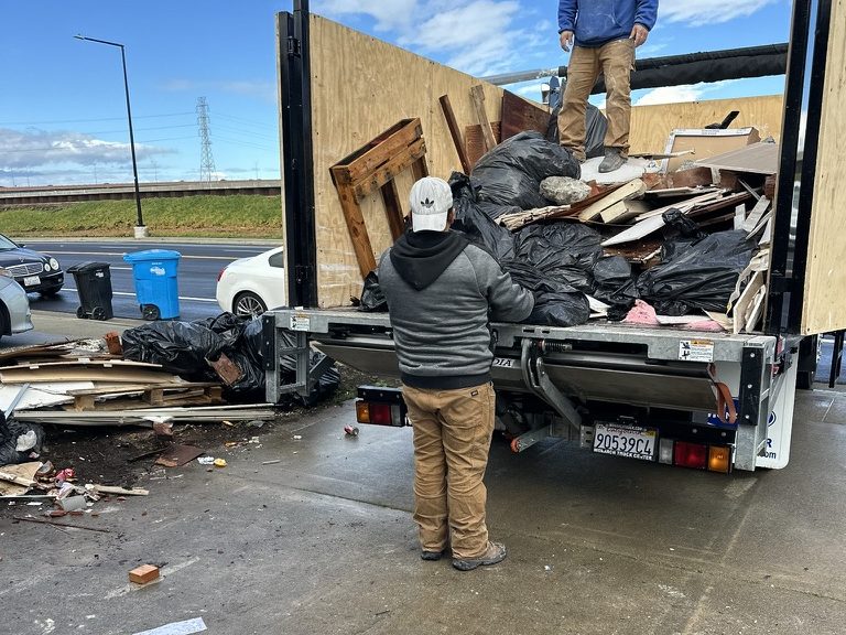 Bay Area Junk & Haul dump truck loaded with household junk and debris